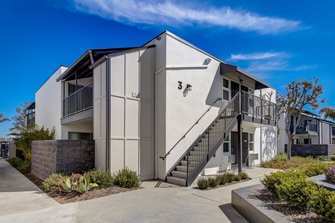 a building with stairs and a blue sky in the background